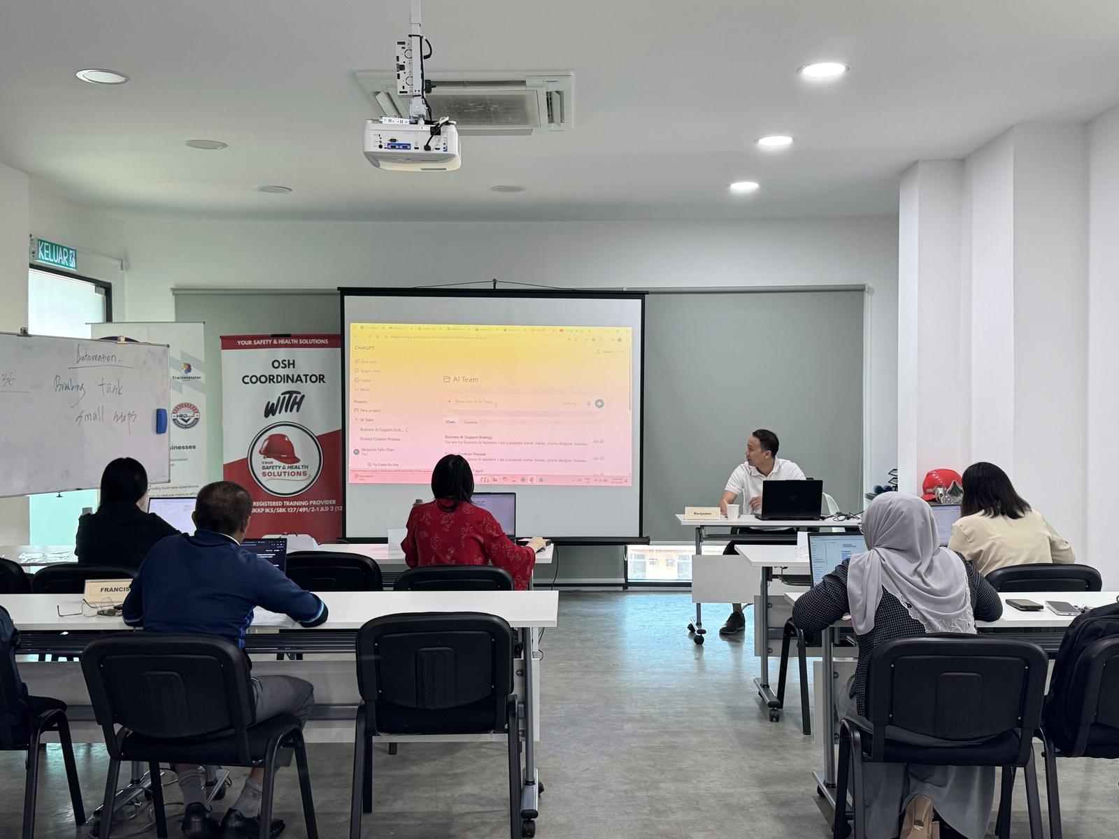 Trainer leading an earlier TMA practical AI class with ChatGPT displayed on screen